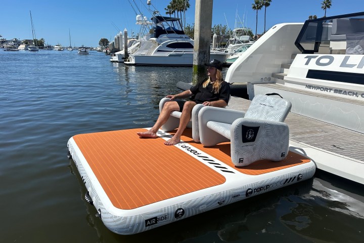 a boat sitting on top of a cutting board with a cake