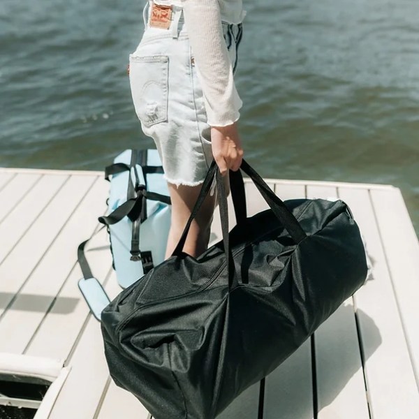 a person standing next to a body of water