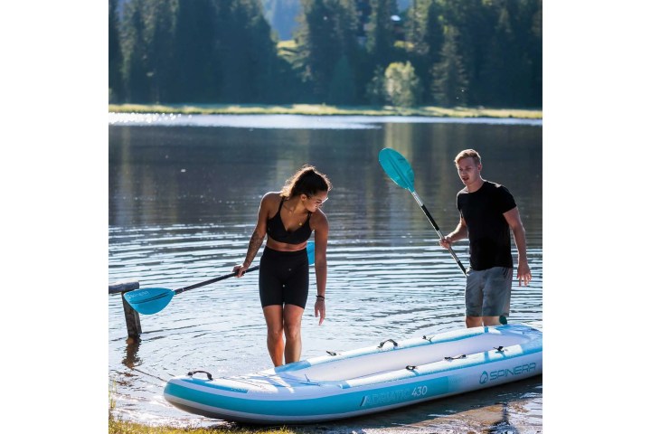 a little girl riding on the back of a boat