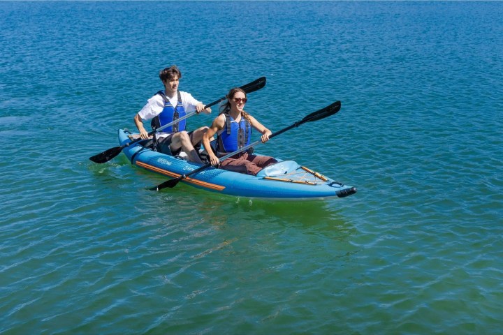 a group of people rowing a boat in a body of water