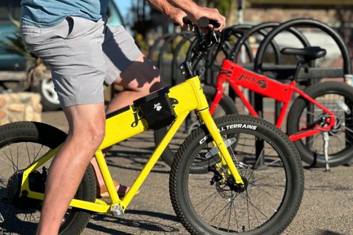 a man standing next to a bicycle